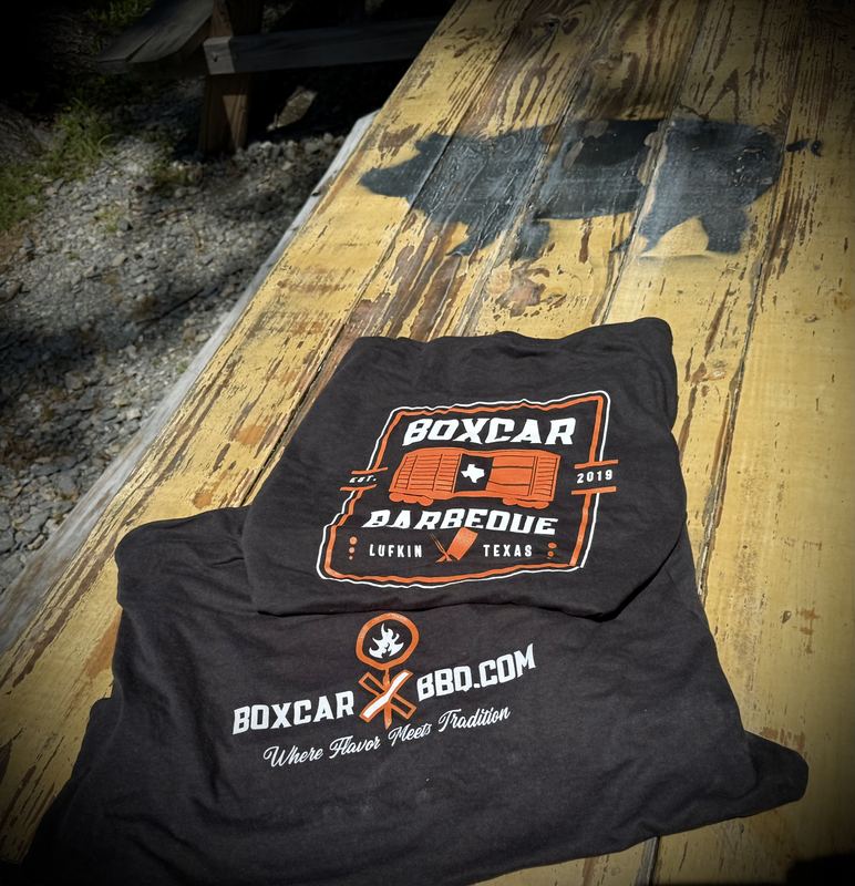 Black Boxcar Barbeque badge T-shirt on a picnic table