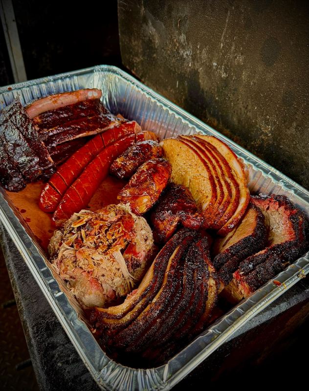 Big pan of ribs, sausage, turkey, pulled pork and sliced brisket